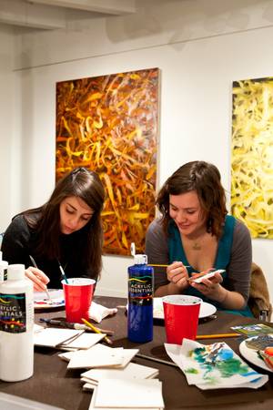Alexandra Gutierrez, 23, and Shanna Rosing, 22, work on painted squares.